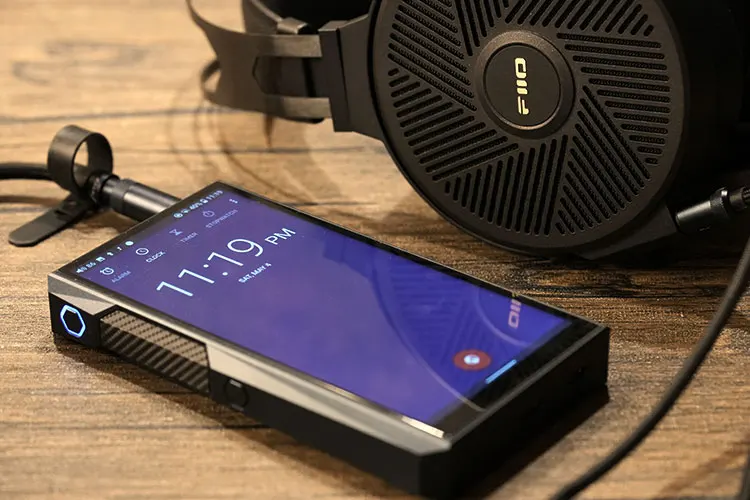 FiiO M23 beside FiiO FT5 headphones